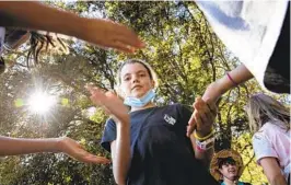  ?? ANA RAMIREZ U-T ?? From left, sixth-graders from Aviara Oaks Middle School Rachel Stein, Layla Smith and Taylor Duralde, all 11, play a game at Camp Marston on Tuesday.