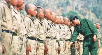  ??  ?? (left) No one knows how many child soldiers are still in Myanmar’s military but those who have been released like Su (below) have had problems reintegrat­ing into society.