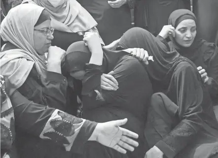  ?? JAAFAR ASHTIYEH/AFP VIA GETTY IMAGES ?? Relatives of 15-year-old Palestinia­n Imad Hashash mourn at his funeral Tuesday in the north of the occupied West Bank.