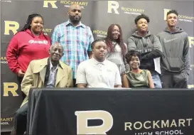  ?? Kevin Myrick / SJ ?? Jay Hinkle is joined by his family for RHS Signing Day.