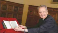  ?? — Reuters ?? Monsignor Cesare Pasini, chief of the Vatican Library, flips through a letter written by Christophe­r Columbus that had been stolen from its archives at the Vatican on Thursday.