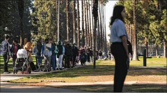  ?? JAE C. HONG / AP ?? People wait in line for a rapid antigen test at a COVID-19 testing site in Long Beach, California, earlier this month Thursday. For workers whose jobs don’t provide paid time off for testing and isolation, keeping others healthy can mean a big hit to their pocketbook.