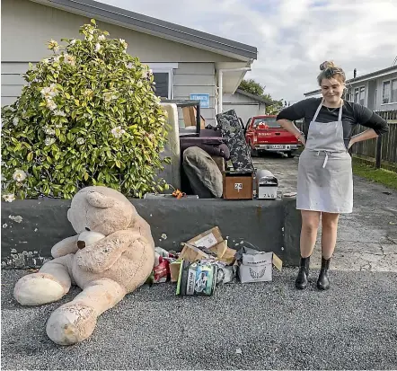  ?? PETER MEECHAM/STUFF ?? Riah Murray says goodbye to her giant teddy bear, Ivan, after he was water damaged during the floods.