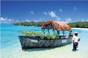  ?? Picture: GREATSTOCK/
CORBIS ?? FLOATING FLOWERS: A guide and his decorated tour boat off Île aux Cerfs