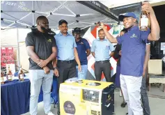  ?? ?? The prize winner of African Distillers’ Viceroy competitio­n, Mr Trymore Sithole (right), celebrates after being handed over a generator by the company’s sales representa­tive Mr Frank Chitiyo (left), while other officials look on in Harare yesterday.— Picture: Memory Mangombe