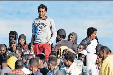  ?? Giovanni Isolino AFP/Getty Images ?? PEOPLE wait aboard a coast guard rescue ship in Italy. Another migrant rescue vessel has been denied entry.