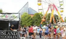  ?? STAFF FILE PHOTO ?? Festival-goers stand in line for food from the Island Noodles vendor booth during the third day of Riverbend Festival in 2019.