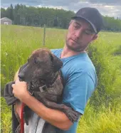  ?? DAVE MOTHUS PHOTO ?? Michel Landry holds Dozer, a nineyear-old dachshund, who became the focal point of a weeklong search east of the city after he escaped following a vehicle accident that hospitaliz­ed his owner.