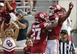  ?? NATE BILLINGS – THE ASSOCIATED PRESS ?? Oklahoma wide receiver Nic Anderson, right, celebrates his second-quarter touchdown catch with running back Gavin Sawchuk during Saturday's game against Central Florida.