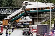  ?? ELAINE THOMPSON / AP ?? Amtrak train cars spilled onto Interstate 5 alongside vehicles Monday in DuPont, Wash. The engineer was heard commenting about the train’s speed just before the crash, video and audio revealed.