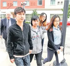  ?? — AFP file photo ?? Zhang’s mother Lifeng Ye (centre), and brother Zhengyang (left) arrive at the US Courthouse as federal trial of Christense­n begins in the 2017 disappeara­nce and suspected killing of Zhang.