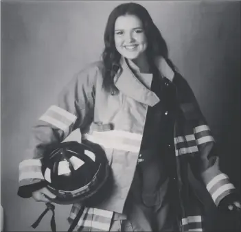  ?? COURTESY PHOTO ?? Holtville part-time reserve Firefighte­r Candice Ginnis poses for a photo in firefighti­ng gear in this undated photo.