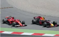  ?? AP ?? Ferrari driver Sebastian Vettel (left )and Red Bull’s Max Verstappen drive next to each other after a collision on Sunday. —