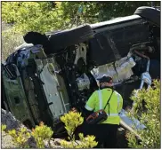  ?? (AP/Marcio Jose Sanchez) ?? An official checks over the accident site where golfer Tiger Woods was involved in a single-car crash Tuesday morning in the Los Angeles suburb of Rancho Palos Verdes, Calif. Woods suffered serious leg injuries.