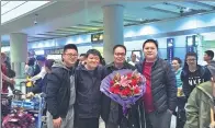  ?? PROVIDED TO CHINA DAILY ?? Colleagues of Cao Hongguo gather at the airport to welcome him back home.