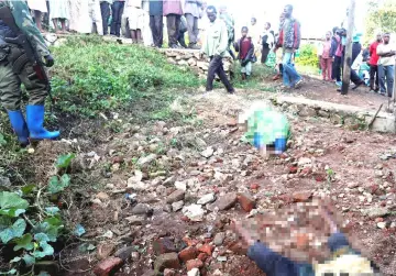  ?? — Reuters photo ?? People look at the bodies of five women, after they were killed in Paida near Beni, North Kivu Province of Democratic Republic of Congo.