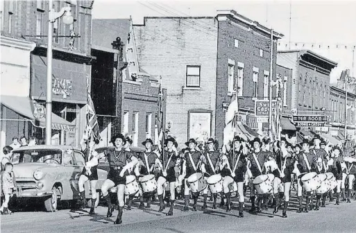  ?? GREG PAUTLER PHOTOS ?? Shortly after splitting from the Boy Scouts of Canada in 1954, the Scout House Band shows off its controvers­ial new red, black and white, non-Scout uniforms. Led here by drum major Paul Bauer, the band marches along King Street East in Preston.