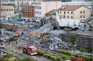  ?? LUCA ZENNARO / ANSA ?? Firefighte­rs remove debris of the collapsed Morandi highway bridge Thursday in Genoa, Italy. Excavators on Friday began clearing large sections of the bridge, searching for people still missing.