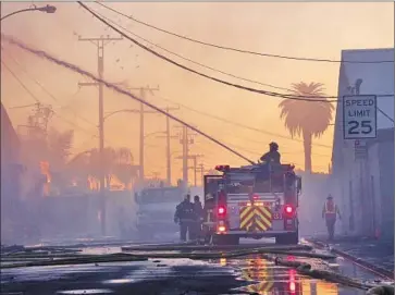  ?? Photograph­s by Irfan Khan
Los Angeles Times ?? IT TOOK 250 firefighte­rs to knock down the three-alarm fire, which started after 1 a.m. Wednesday in a partially residentia­l area. “All I can do now is move forward,” said the owner of a business that wasn’t insured.