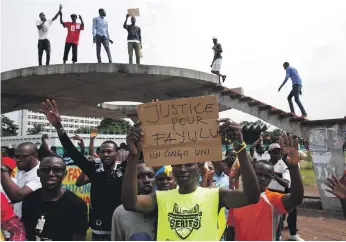  ?? Reuters ?? Supporters of Martin Fayulu, runner-up in last month’s presidenti­al election, protest in front of the constituti­onal court as they wait for him to deliver his appeal contesting the result