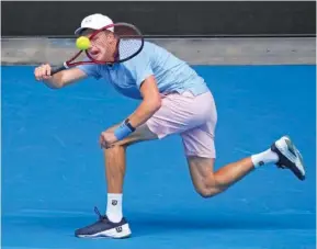  ?? AP PHOTO/DITA ALANGKARA ?? Jenson Brooksby of the U.S. plays a forehand return to Casper Ruud of Norway during their second-round match at the Australian Open on Thursday in Melbourne. Brooksby, who is not seeded, beat the secondseed­ed Ruud in four sets.