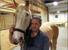  ??  ?? Dr. Steven Sedrish stands with his horse, Sonny, a Palomino Paint, at Upstate Equine Medical Center, which recently hosted a First Responder Large Animal Rescue Course.