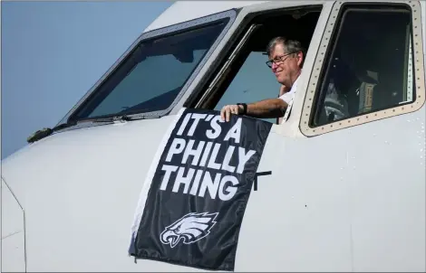  ?? MATT YORK — THE ASSOCIATED PRESS ?? A Philadelph­ia Eagles flag is held as the team’s plane arrives in Phoenix ahead of Super Bowl LVII.
