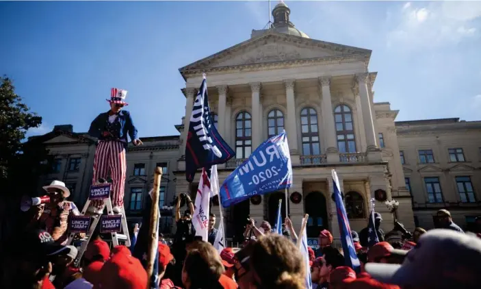  ?? Photograph: Nathan Posner/Rex/Shuttersto­ck ?? Trump supporters at a ‘Stop the Steal’ rally outside of the Georgia state capitol on 21 November.