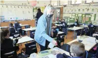  ??  ?? GRADE 1 pupils at Durbanvill­e Preparator­y School have their hands sanitised as learners begun returning to school acroos the country.