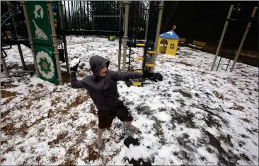  ?? PATRICK TEHAN — STAFF PHOTOGRAPH­ER ?? Nathaniel Wilkerson, 10, of Los Gatos, plays in the snow at the Redwood Estates Neighborho­od Park on Thursday. The Santa Cruz Mountains experience­d snowfall overnight, with a freeze warning issued for the area through this morning.