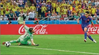  ?? FRANK AUGSTEIN / THE ASSOCIATED PRESS ?? Colombia’s Radamel Falcao, right, scores the second goal for his side past Poland goalkeeper Wojciech Szczesny during the group H match between Poland and Colombia, Sunday at the Kazan Arena in Kazan, Russia.