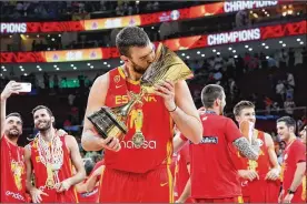  ?? LINTAO ZHANG / GETTY IMAGES ?? Marc Gasol of Spain, holding the winning trophy, celebrates after defeating Argentina in the final of the 2019 FIBA World Cup between Argentina and Spain at Beijing Wukesong Sport Arena on Sunday in Beijing, China.