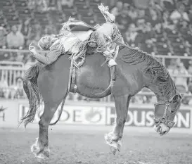  ?? J. Patric Schneider ?? Tyler Nelson held on long enough in the bareback riding semifinal Thursday at RodeoHoust­on, tying with Mason Clements for first to earn a spot in the finals.
