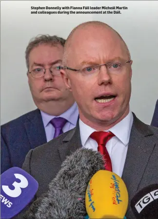  ??  ?? Stephen Donnelly with Fianna Fáil leader Micheál Martin and colleagues during the announceme­nt at the Dáil.
