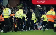  ?? ?? TROUBLE Vieira surrounded by stewards as fans run on