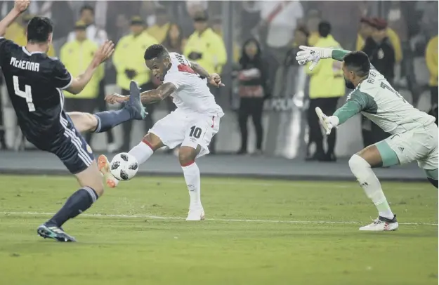  ??  ?? 0 Jefferson Farfan, who won the penalty for the first goal and scored the second, fires in a shot towards Jordan Archer in the Scotland goal during Peru’s 2-0 win in Lima.