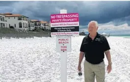  ?? BRENDAN FARRINGTON/AP ?? Bill Hackmeyer walks on the beach near his condo, in Santa Rosa Beach, Fla. Hackmeyer defends his fight to keep the public off the private beach in front of his gated community.