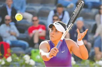  ?? ALBERTO LINGRIA/REUTERS ?? Canada's Bianca Andreescu returns the ball during her first-round match against Britain's Emma Raducanu at the Italian Open on Tuesday.