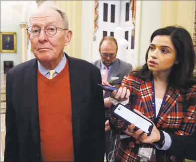  ?? Steve Helber / Associated Press ?? Sen. Lamar Alexander, R-Tenn., talks to reporters as he walks past the Senate chamber prior to the start of the impeachmen­t trial of President Donald Trump at the U.S. Capitol on Friday.