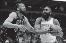  ?? [MORRY GASH/THE ASSOCIATED PRESS] ?? James Harden of the Rockets drives past Jabari Parker of the Bucks during the first half Wednesday in Milwaukee.