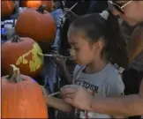  ?? PHOTOS TOM BODUS ?? BottoM: Kids attending the third annual Brawley elks Lodge Rib Cook-off had the opportunit­y to decorate a pumpkin and play a variety of free games.