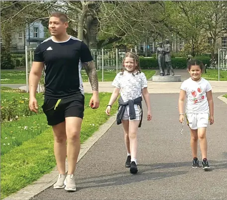  ??  ?? Former Kilmoyley and Kerry hurler Adrian Royle having a stroll at Tralee Town Park last week with his daughter’s Izzi and Lexi. Photo Moss Joe Browne.