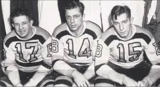  ?? B Bennett / Getty Images ?? Bobby Bauer, Woody Dumart and Milt Schmidt of the Bruins pose for a photograph before their last game before joining the Royal Canadian Air Force in 1942.