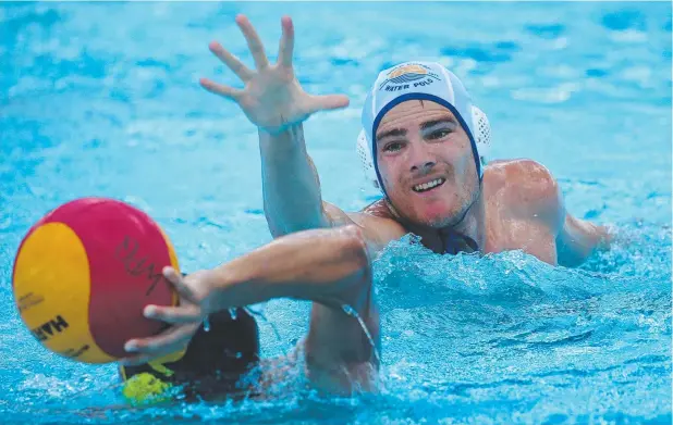  ?? Picture: STEWART McLEAN ?? TOUGH GAMES: Sunshine Coast's Dylan Coolican tries a pass over Gold Coast's Cameron Wallace in the grand final of the water polo championsh­ips.