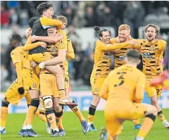  ?? AFP ?? Cambridge players celebrate on the pitch after beating Newcastle.