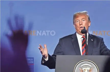  ?? GEERT VANDEN WIJNGAERT/AP ?? President Trump declares success Thursday as he wrapped up a tense two-day summit of NATO allies in which he criticized member nations for not meeting their defense spending obligation­s. He’s in the U.K. this weekend.