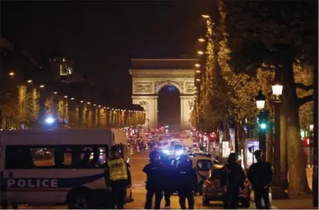  ?? KAMIL ZIHNIOGLU — THE ASSOCIATED PRESS ?? Police seal off the Champs Elysees avenue in Paris, France, after a fatal shooting in which a police officer was killed along with an attacker, Thursday. French media are reporting that two police officers were shot Thursday on the famed shopping...