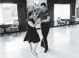  ?? Susan Haigh / Associated Press ?? Dance instructor Ned Pavlovic, a native of Serbia, teaches Rouhy Yazdani in October at the Fred Astaire Dance studio in Orange, Conn. Studio owners are struggling to find instructor­s.