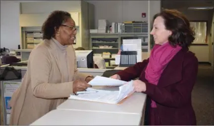  ?? BRIANA CONTRERAS — THE MORNING JOURNAL ?? From left, Clerk at the Lorain County Board of Elections office, Debrah McAfee, guides Leah Sellers, entreprene­ur and attorney, as she files a petition at the Board of Elections office, 1985 N. Ridge Road in Lorain on Feb. 7. Sellers is running for the...