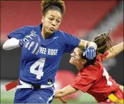  ?? ANNIE RICE/AJC ?? Peachtree Ridge’s Monique Thame (left) runs past North Gwinnett during the finals of the girl’s flag football championsh­ips Thursday at Mercedes-Benz Stadium. Thame is a quarterbac­k on the team.